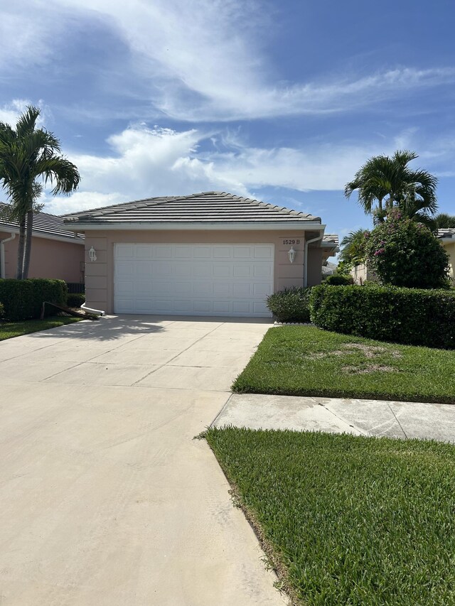 view of front of home with concrete driveway and a tile roof