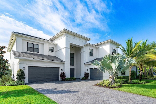 view of front of property with a garage and a front yard