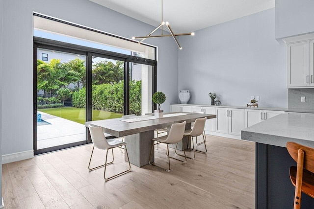 dining area with a notable chandelier and light wood-type flooring