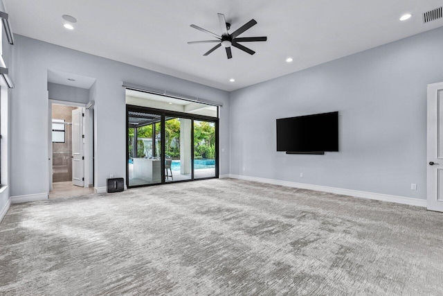 unfurnished living room with carpet flooring and a wealth of natural light