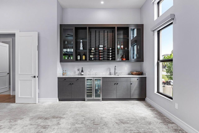 bar featuring wine cooler and sink