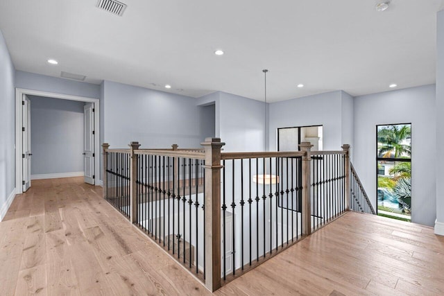 corridor with light hardwood / wood-style flooring