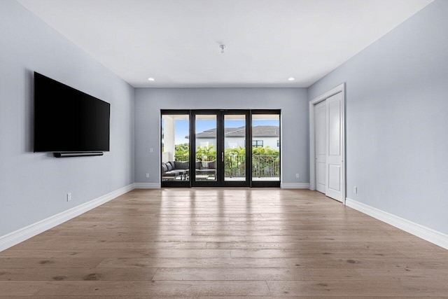 unfurnished living room with light hardwood / wood-style flooring