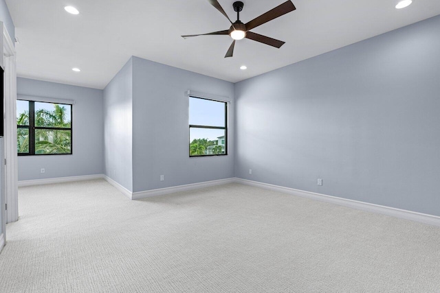 carpeted spare room with ceiling fan