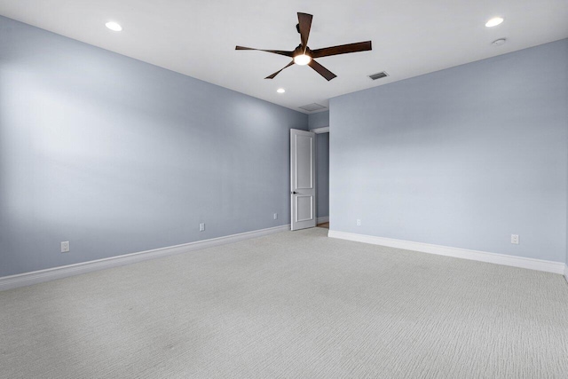 unfurnished room featuring light carpet and ceiling fan