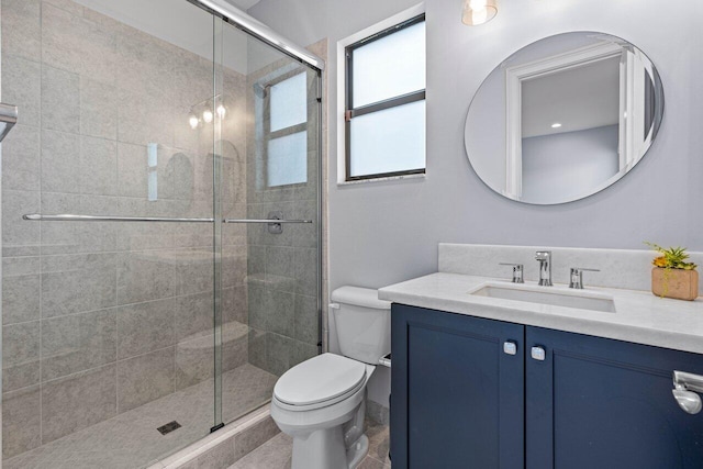 bathroom featuring walk in shower, tile patterned flooring, vanity, and toilet