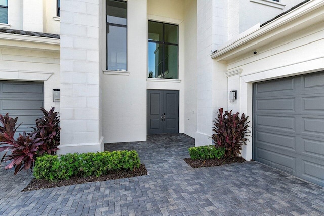 view of exterior entry featuring a garage