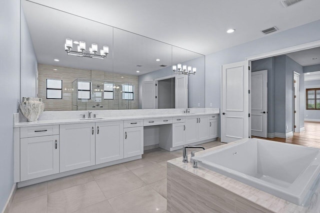 bathroom featuring tile patterned floors, plus walk in shower, and vanity