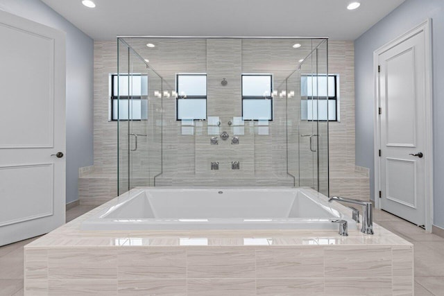 bathroom featuring tile patterned floors, plenty of natural light, and separate shower and tub