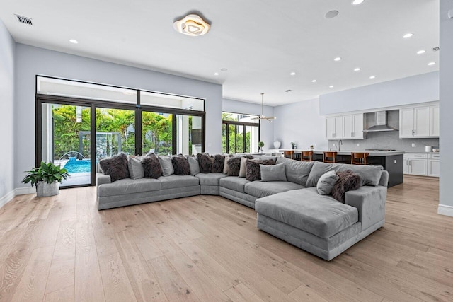 living room featuring light hardwood / wood-style floors and sink