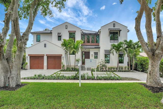 view of front of property with a front lawn and a garage