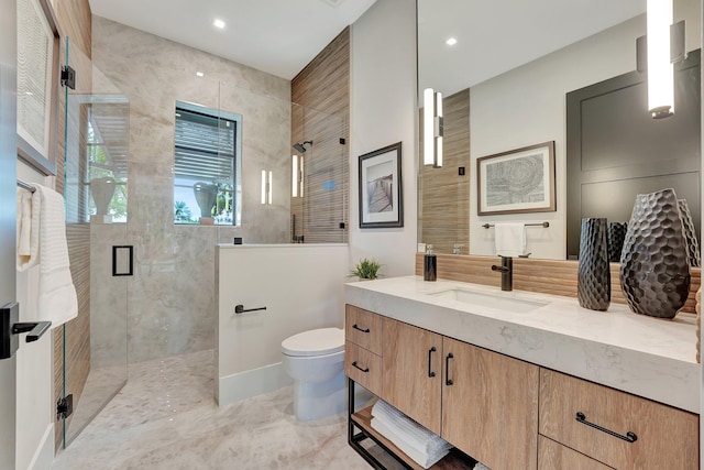 bathroom featuring tile patterned flooring, toilet, vanity, and a shower with shower door