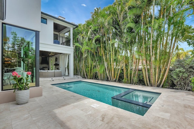 view of pool with outdoor lounge area, a patio area, and a pool with connected hot tub