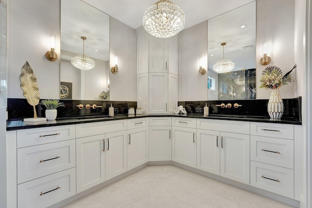 bathroom with a chandelier, vanity, visible vents, decorative backsplash, and walk in shower