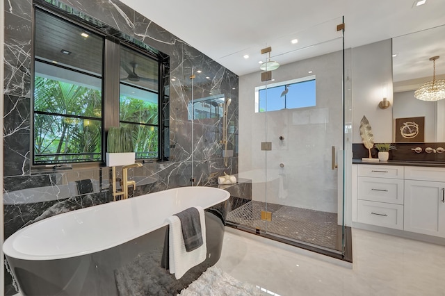 full bathroom featuring a soaking tub, a shower stall, vanity, and tile walls