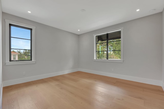 unfurnished room featuring baseboards, recessed lighting, and light wood-style floors