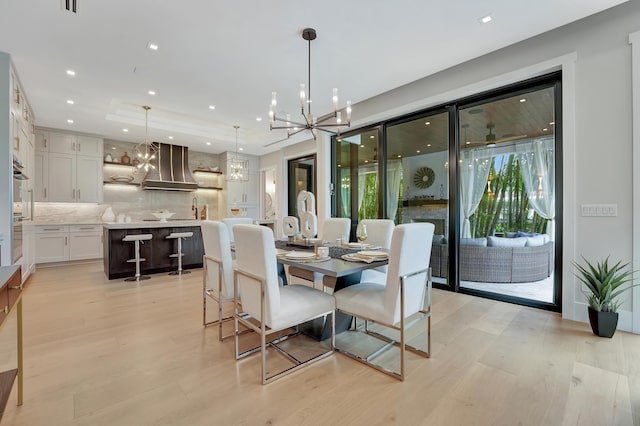 dining area featuring a chandelier, recessed lighting, and light wood finished floors