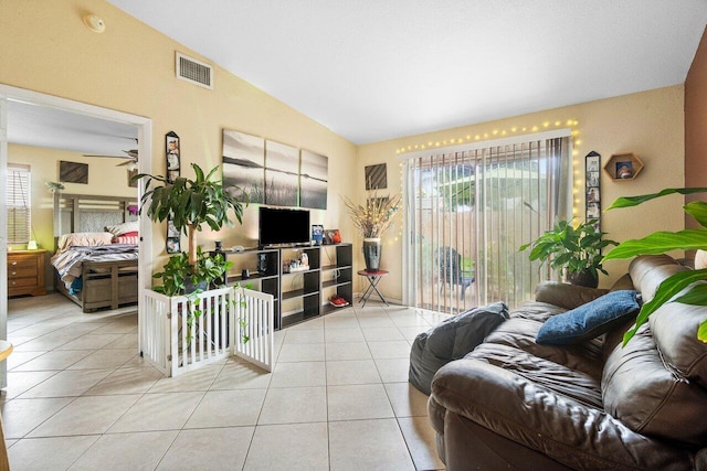 tiled living room featuring lofted ceiling and ceiling fan