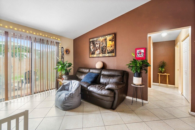 living room with lofted ceiling and light tile patterned floors