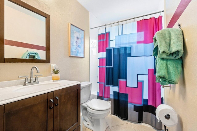 bathroom featuring vanity, tile patterned flooring, and toilet