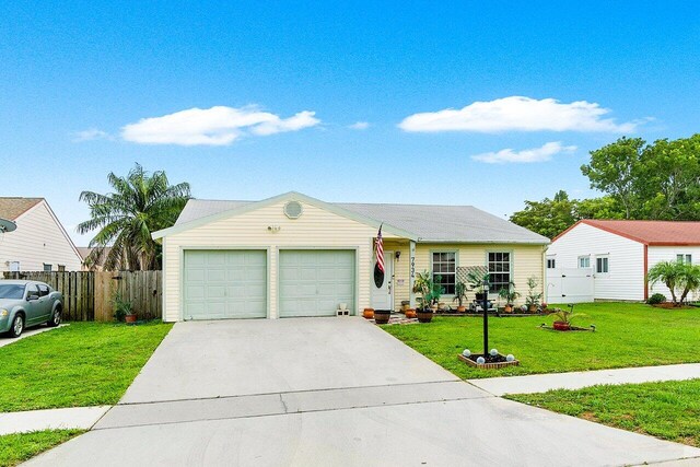 view of front of property featuring a garage and a front yard