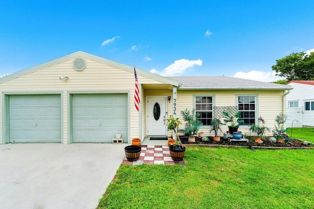 ranch-style home featuring a garage and a front lawn