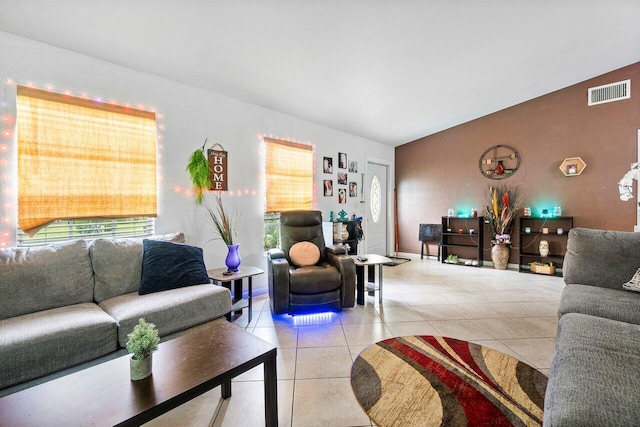 living room featuring tile patterned flooring and vaulted ceiling