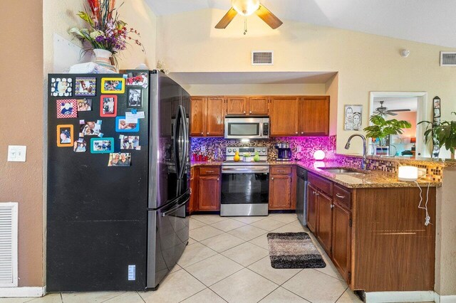 kitchen with sink, ceiling fan, backsplash, and stainless steel appliances