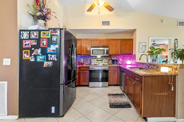 kitchen with sink, ceiling fan, backsplash, and stainless steel appliances