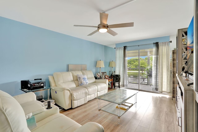 living room with ceiling fan and light hardwood / wood-style floors