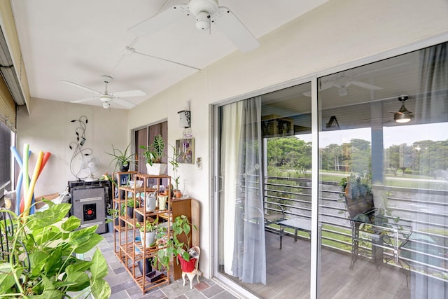 sunroom featuring ceiling fan