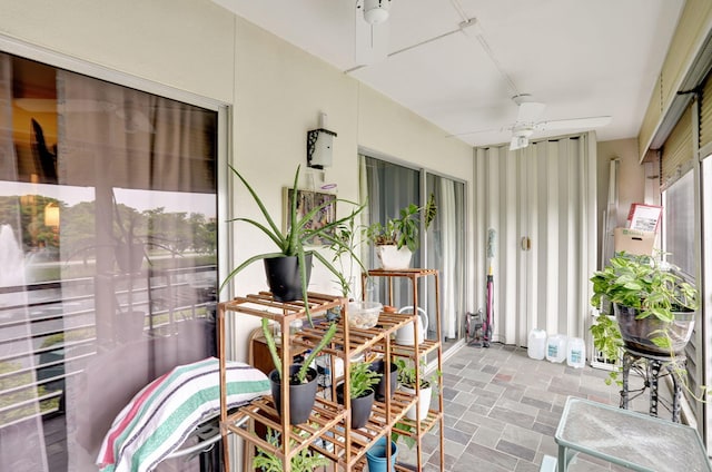 sunroom / solarium featuring ceiling fan