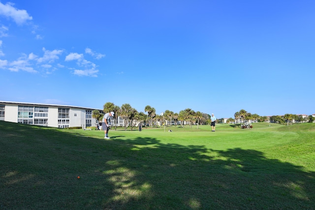 view of property's community featuring a yard