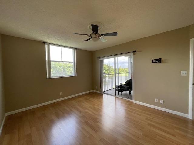 empty room featuring a textured ceiling, ceiling fan, and light hardwood / wood-style floors