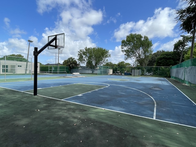 view of basketball court featuring tennis court