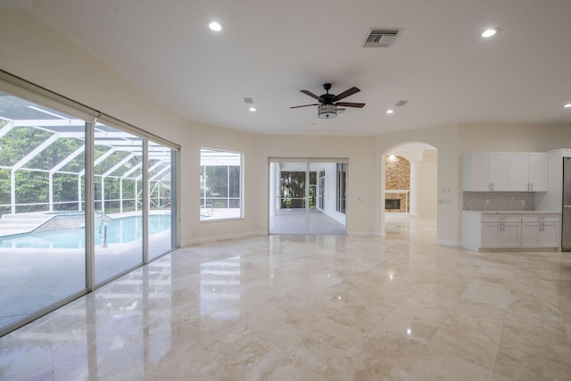 unfurnished living room featuring ceiling fan