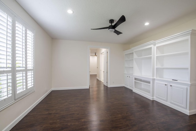 unfurnished living room with ceiling fan and dark hardwood / wood-style flooring