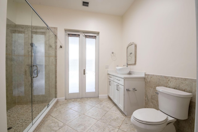 bathroom with toilet, vanity, french doors, and tile patterned flooring