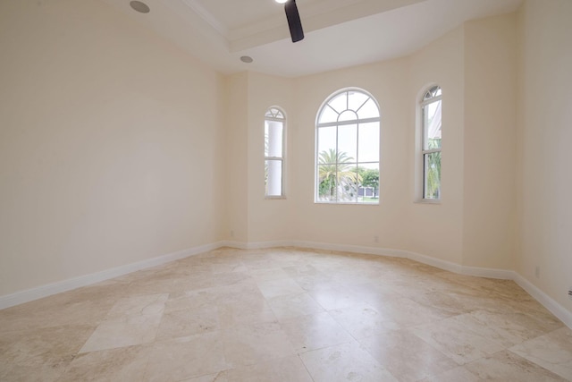 spare room featuring ceiling fan and ornamental molding