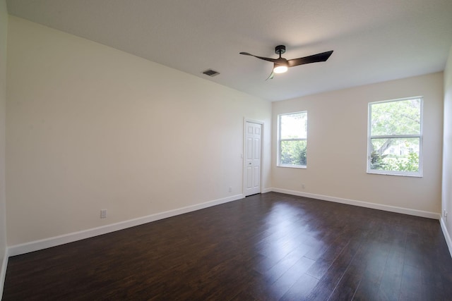 empty room with ceiling fan and dark hardwood / wood-style floors