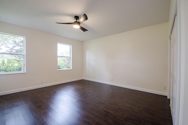 unfurnished bedroom featuring ceiling fan and dark hardwood / wood-style flooring