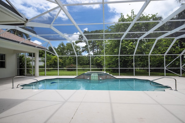 view of pool with glass enclosure, an in ground hot tub, a lawn, and a patio