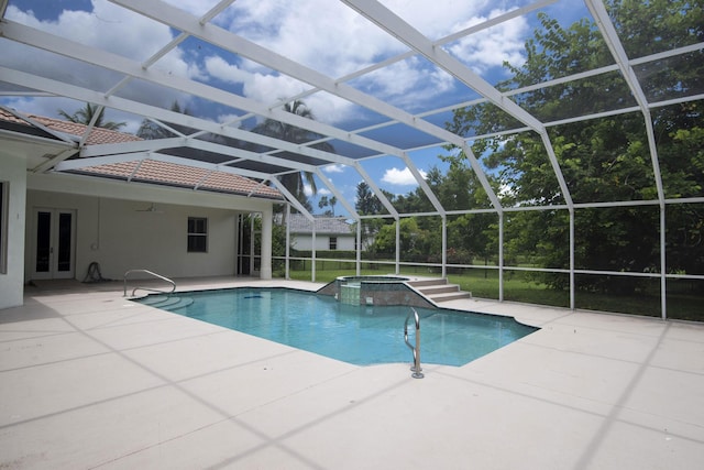 view of swimming pool featuring a lanai, french doors, a patio area, and an in ground hot tub