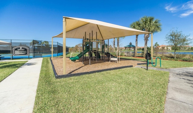 view of jungle gym featuring a lawn