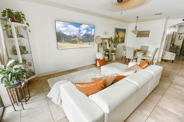 living room with crown molding, light tile patterned floors, and ceiling fan