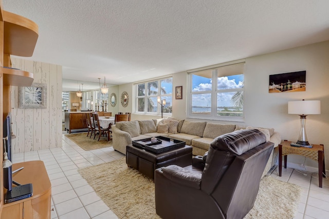 living room featuring a textured ceiling and light tile patterned floors