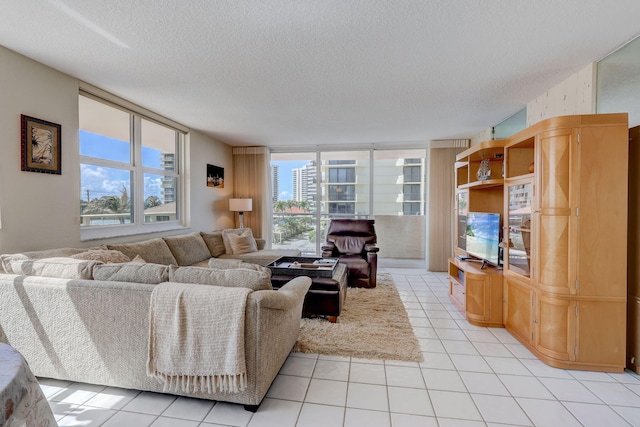 tiled living room featuring floor to ceiling windows and a textured ceiling