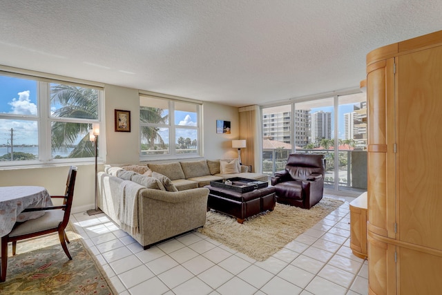 living room featuring a textured ceiling and light tile patterned floors