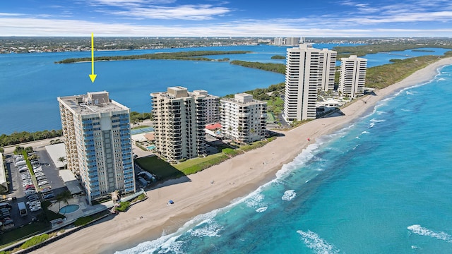 drone / aerial view featuring a beach view and a water view