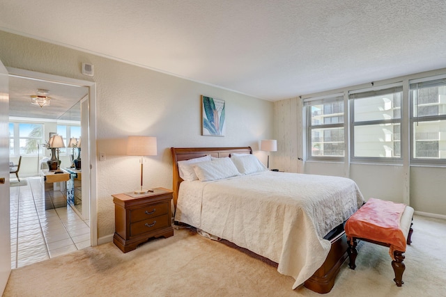 bedroom with tile patterned floors and a textured ceiling